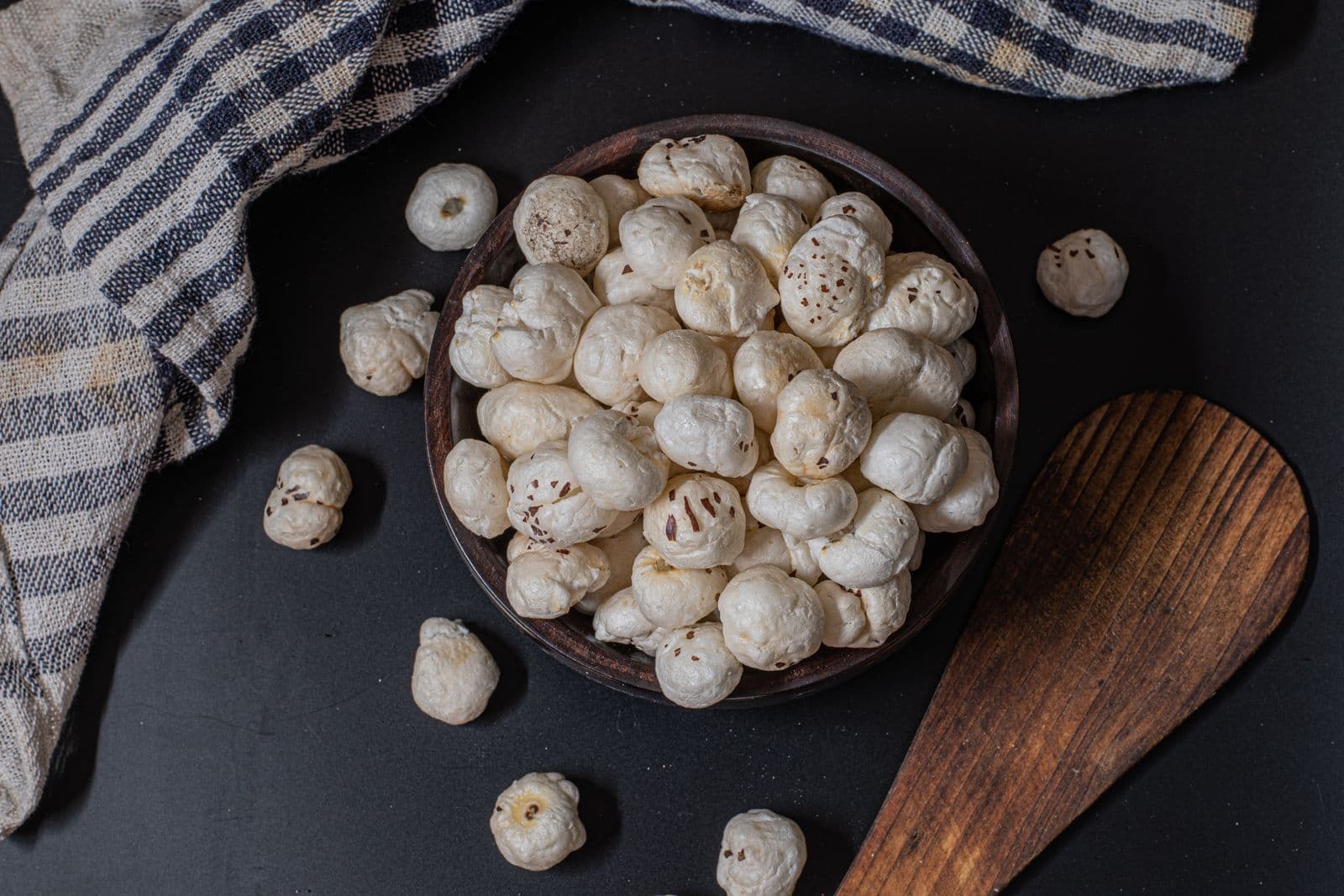 Raw popped makhana (fox nuts) in a wooden bowl, ready to roast, season, or sell as-is